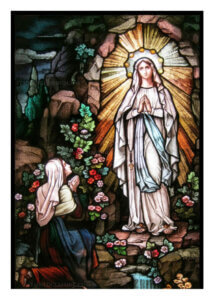 Stained glass of Our Lady of Lourdes appearing to Saint Bernadette