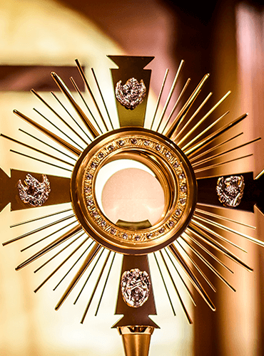 Golden monstrance holding the Blessed Sacrament for adoration
