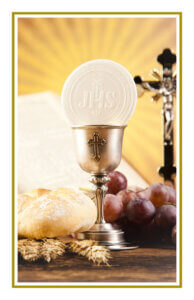 Eucharistic host in chalice with bread, grapes, and crucifix