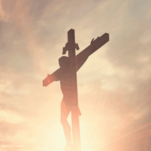 Crucifix of Jesus Christ with radiant sunlight at dawn