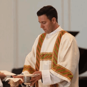 Catholic priest preparing the altar during Holy Triduum Mass