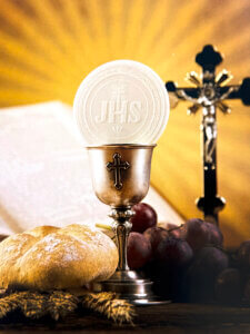 Chalice with host, bread, grapes, and crucifix symbolizing the Eucharistic banquet