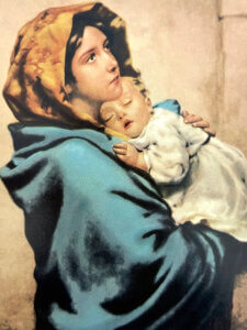 Madonna of the Streets holding the infant Jesus in her arms