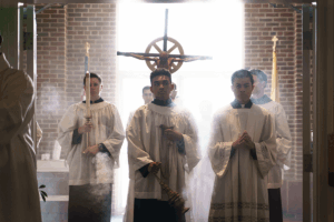 Altar servers participate in the entrance procession by leading the clergy down the center aisle.
