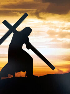 Jesus carrying His cross at sunrise on the way to Calvary
