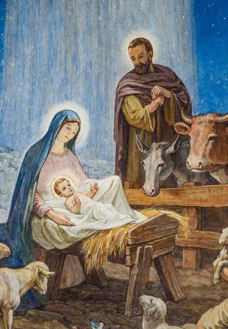 Mary and Joseph with the infant Jesus in the manger surrounded by animals
