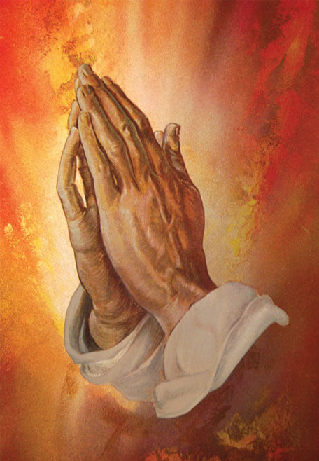 Hands folded in prayer on a radiant background symbolizing faith and surrender