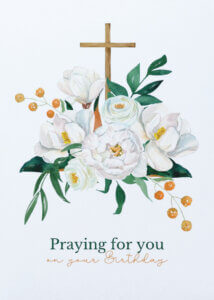 Cross with white flowers and berries, birthday message.