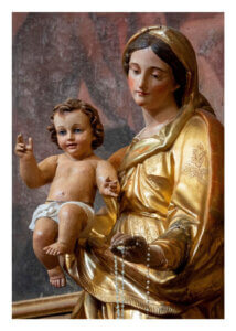 Statue of Mary holding baby Jesus with rosary beads.